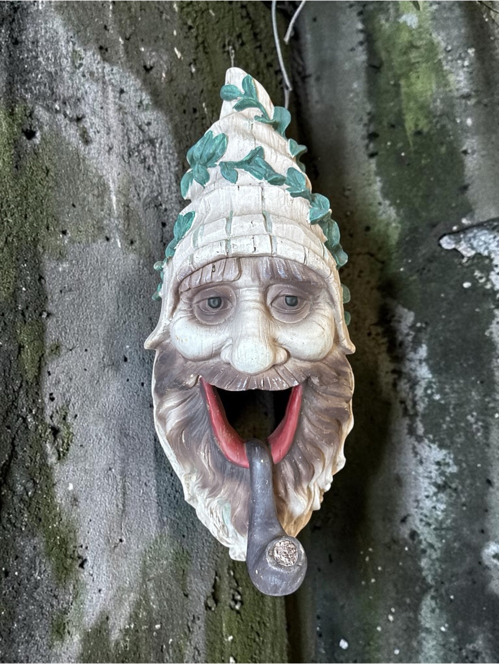 BIRDHOUSE resin gnome head with a pipe and leaf-adorned hat.